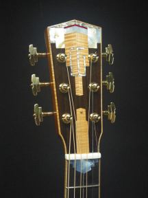 Gold tuning machines adorn the peghead which is inlaid with curly maple and mother of pearl. "CG" are the owner's initials.