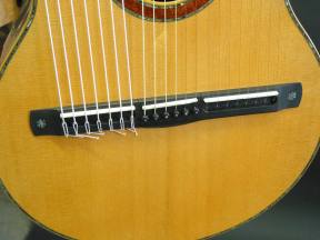 All 21 strings are anchored to the ebony bridge.