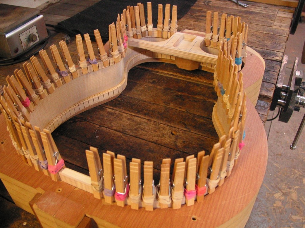 The linings are glued to the sides for reinforcement. Clothespins are used as clamps until the glue dries.
